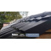 close up image of black plastic roof ridge tile on garden shed