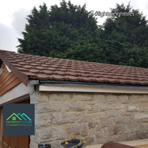 Close up image of brown granulated garage roof replacement by lightweight tiles
