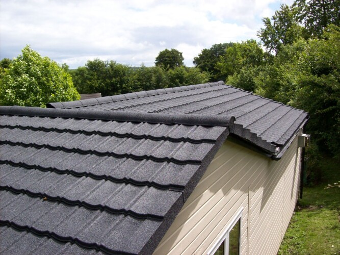 garden office with new lightweight roof tiles in grey